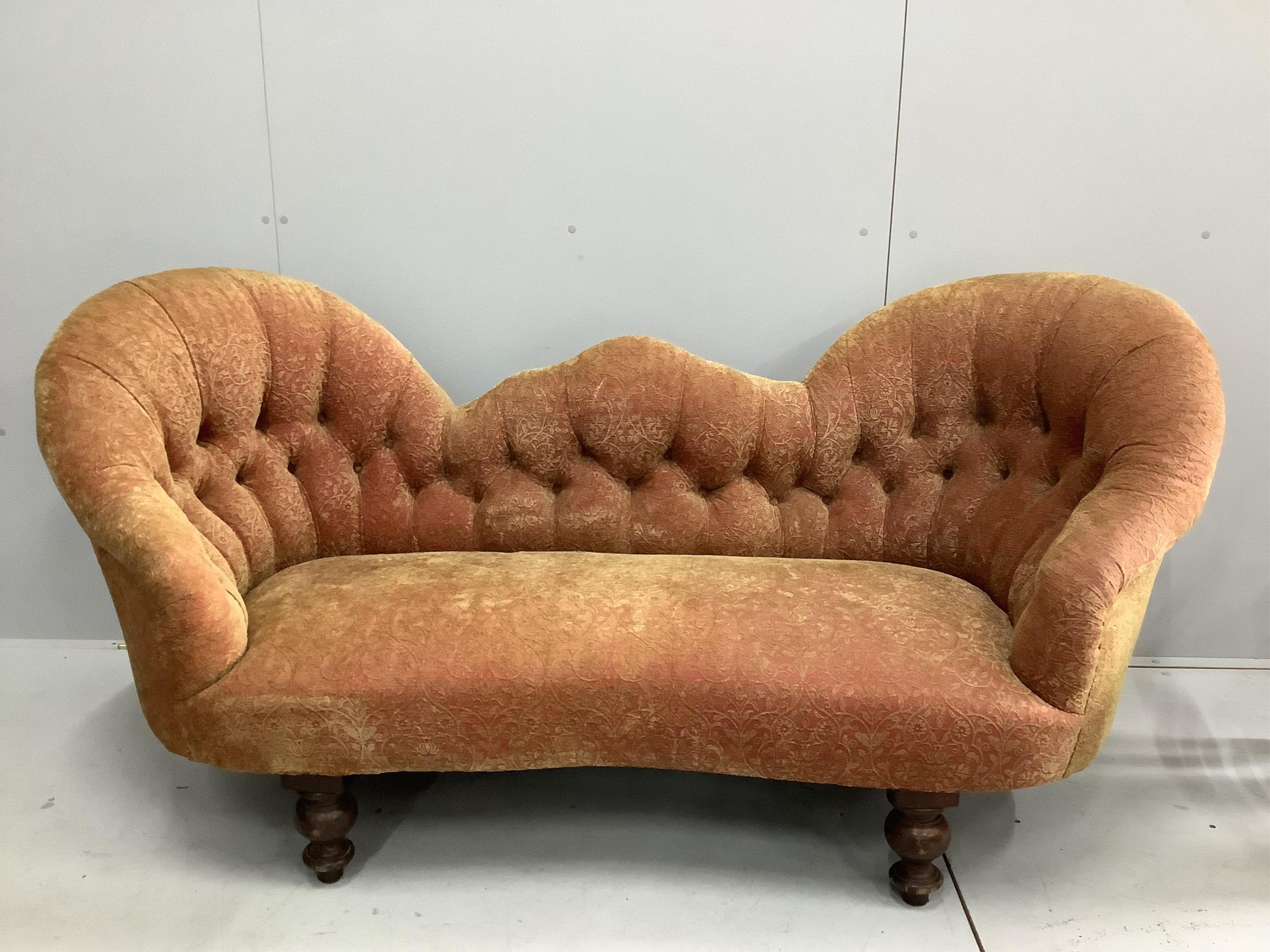 A Victorian double spoon back settee recently reupholstered in buttoned patterned red and gold fabric, width 180cm, depth 72cm, height 83cm. Condition - good